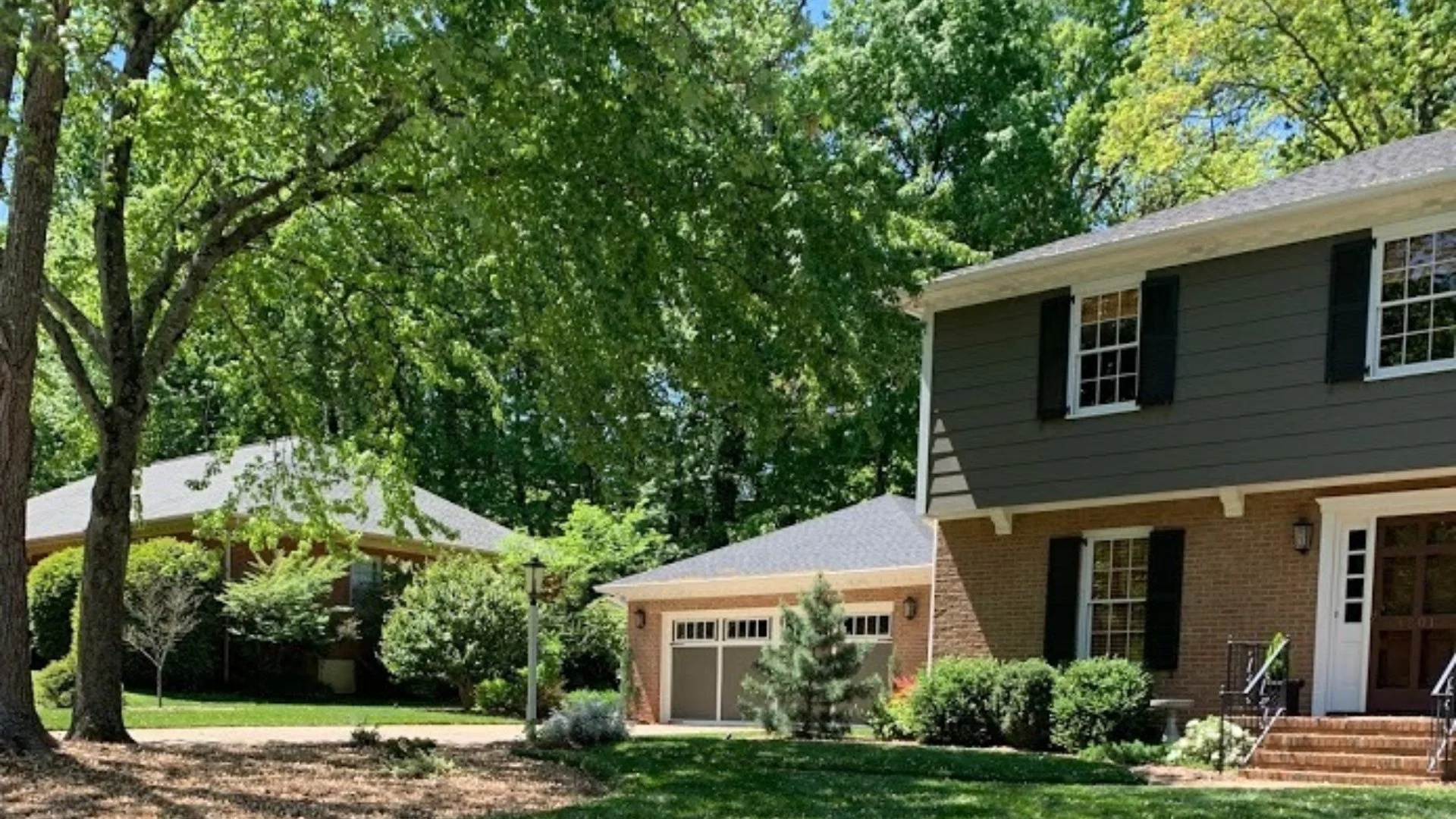 Residential property featuring well-maintained trees and shrubs, showcasing a lush landscape in Indian Trail, NC.