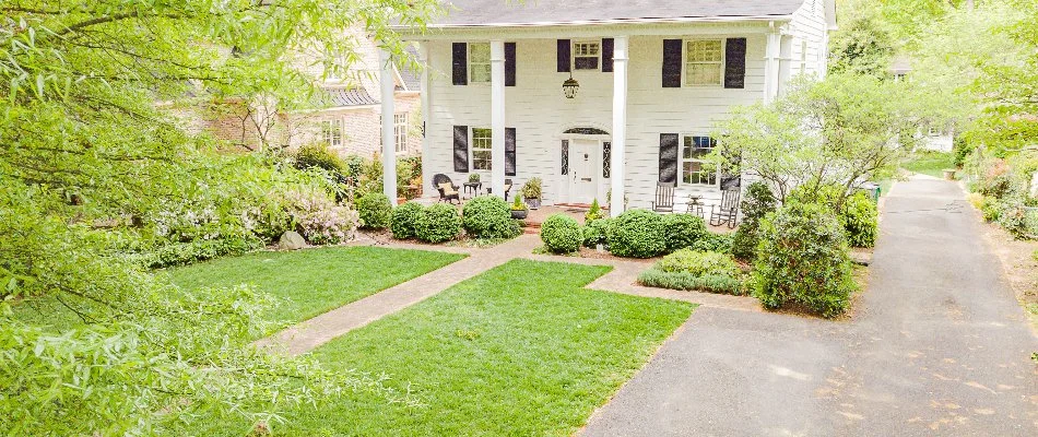 Shrubs, a walkway, and lawn in a front yard in Tega Cay, SC.