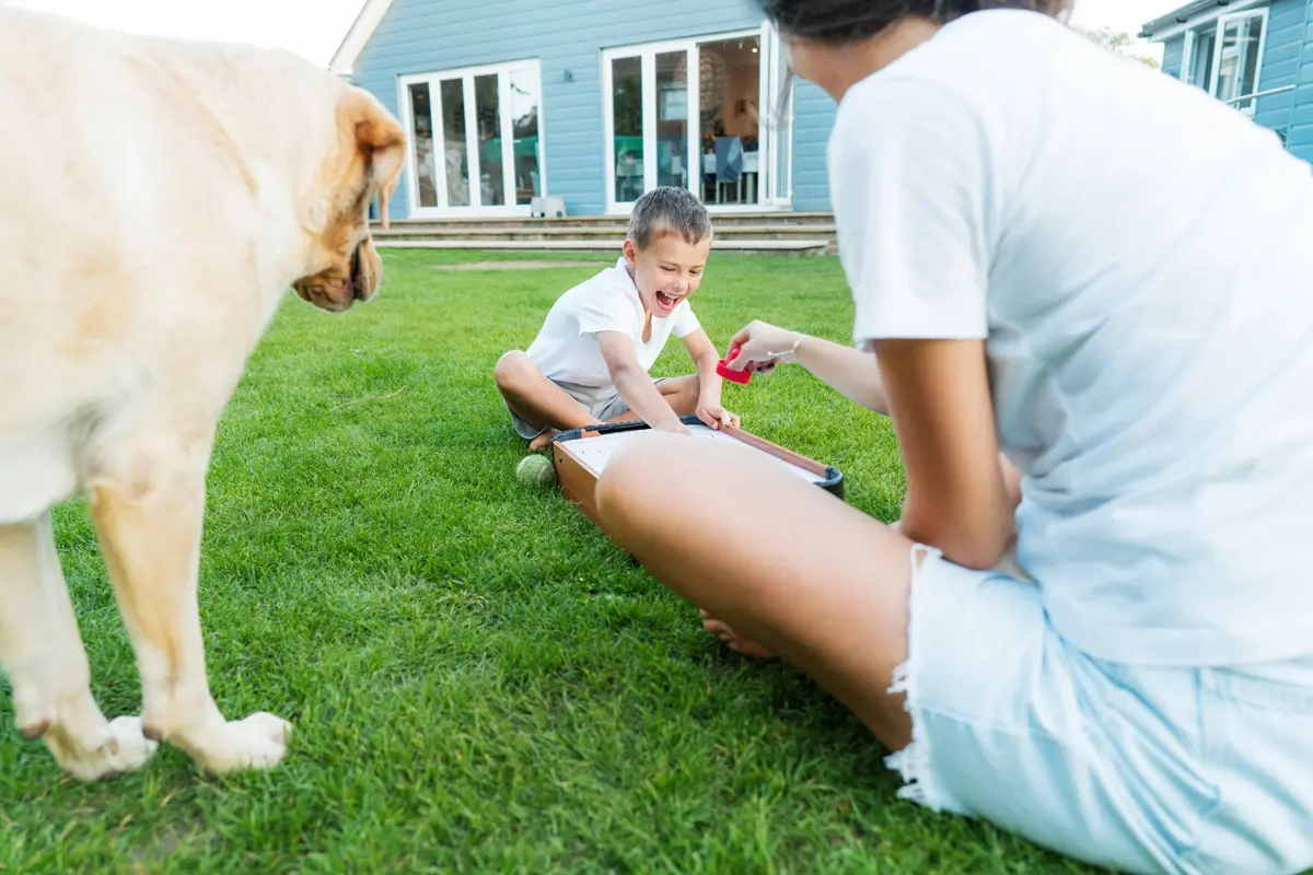 Family and pet playing safely on a professionally treated lawn in Charlotte, NC