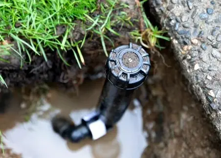 Irrigation repair Charlotte, NC by Fine Turf professional technician fixing broken sprinkler head