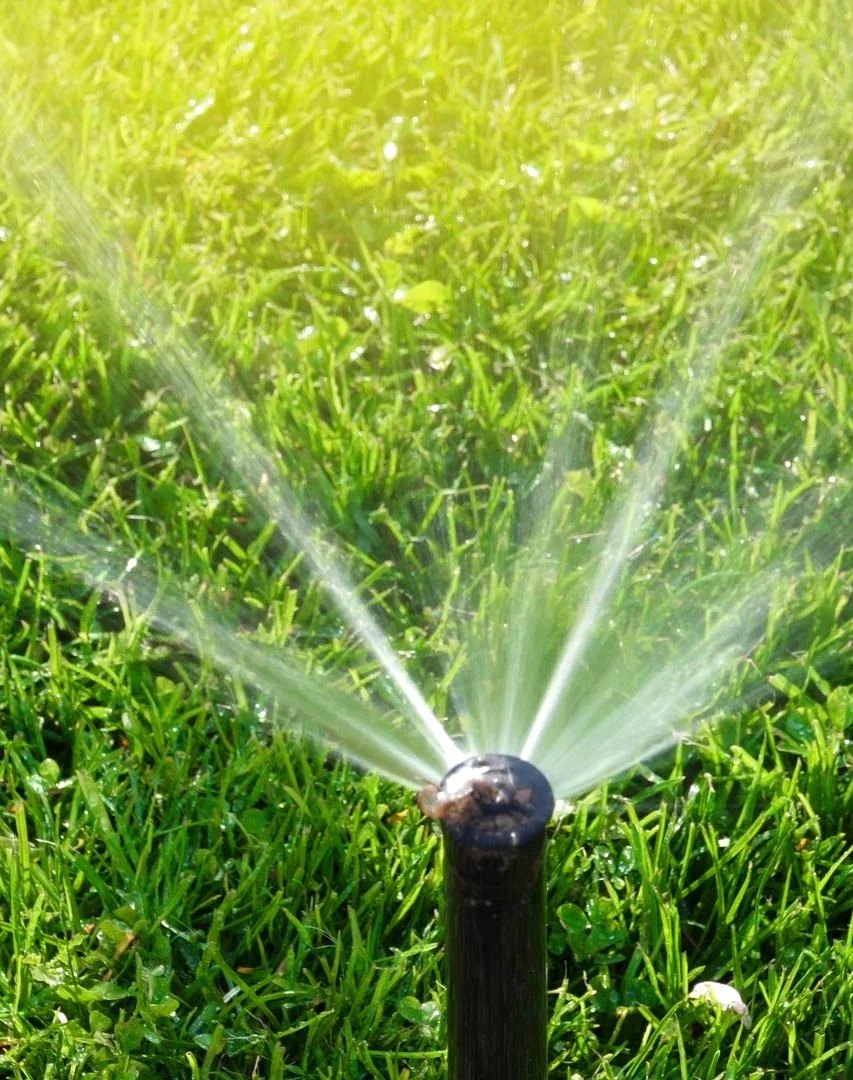 FineTurf technician adjusting irrigation system